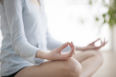 Woman meditating in the lotus position closeup