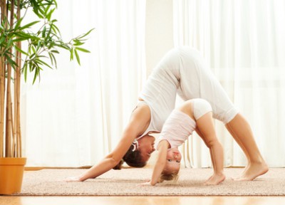 Mother and daughter doing yoga  exercise home. Mother and baby g